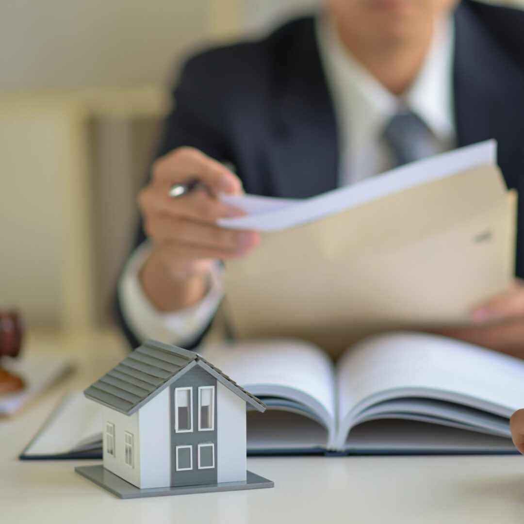 The lawyer is consulting clients about the house purchase contract.